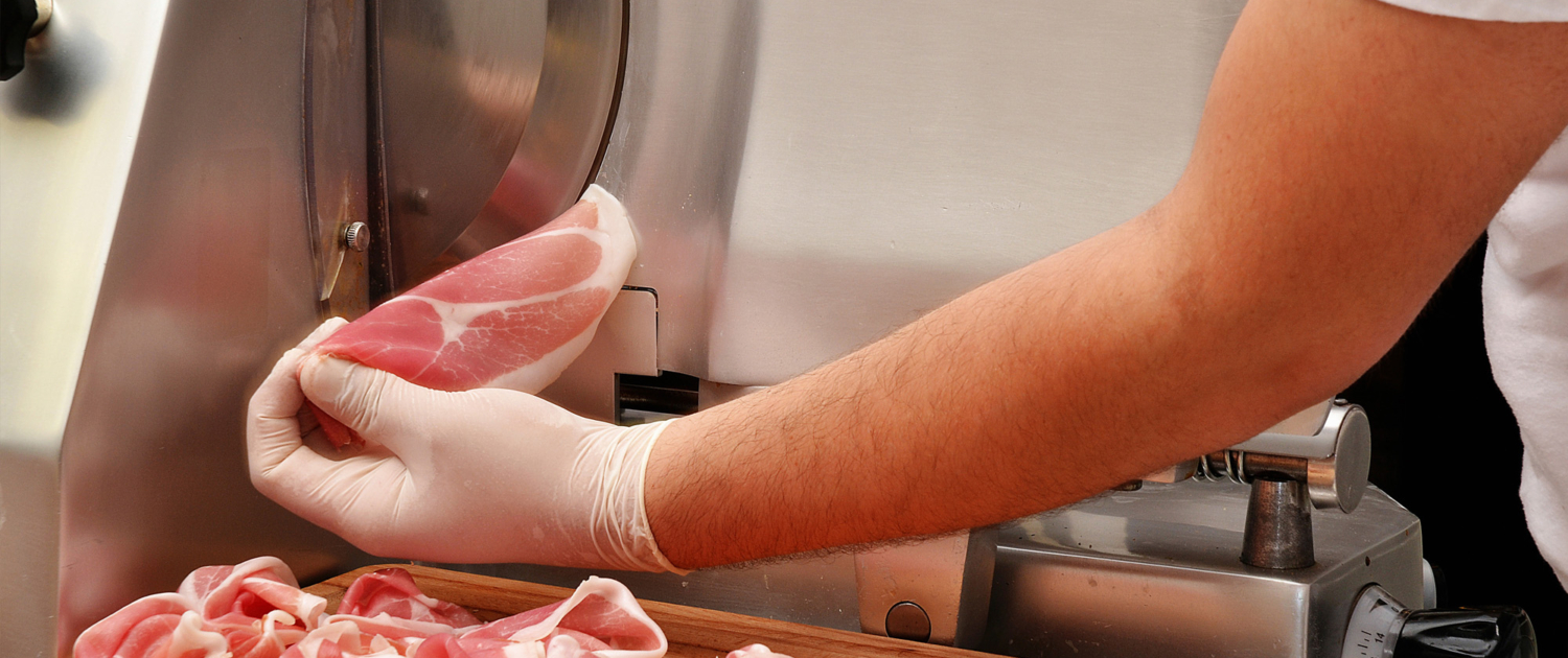 person using deli slicer