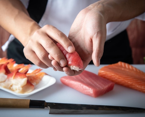 Sushi chef making nigiri sushi